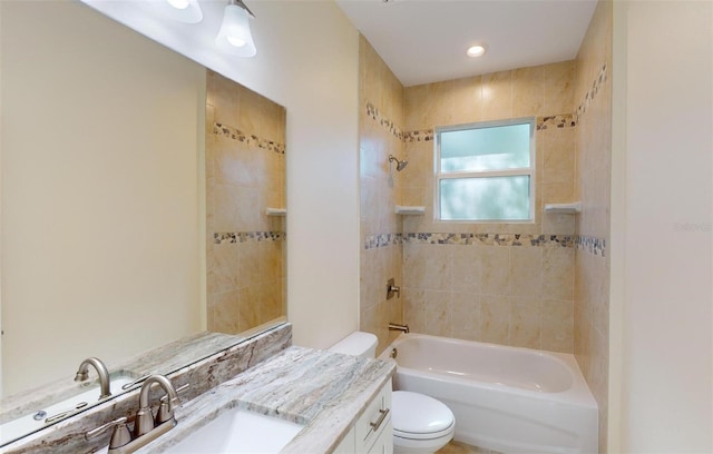 full bathroom with vanity, toilet, and tiled shower / bath