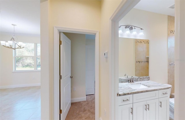 bathroom featuring a chandelier, tile patterned floors, vanity, and toilet