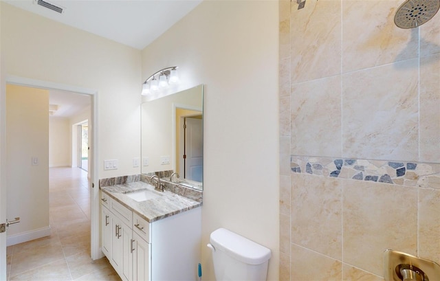 bathroom with tile patterned floors, vanity, toilet, and walk in shower