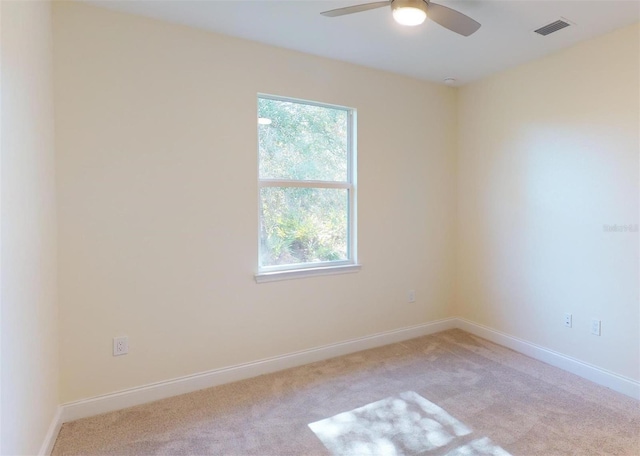 carpeted empty room featuring ceiling fan