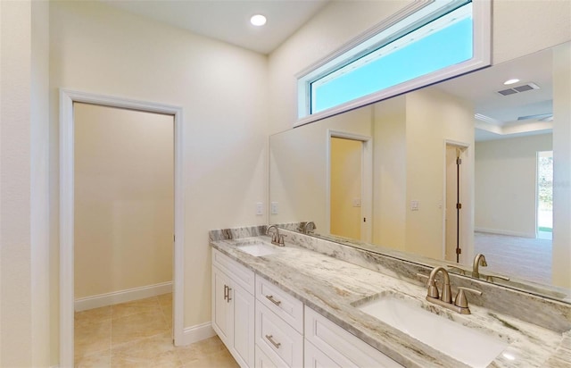 bathroom featuring a tray ceiling and vanity