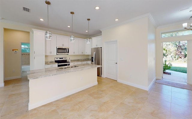 kitchen featuring white cabinets, pendant lighting, a center island with sink, and stainless steel appliances