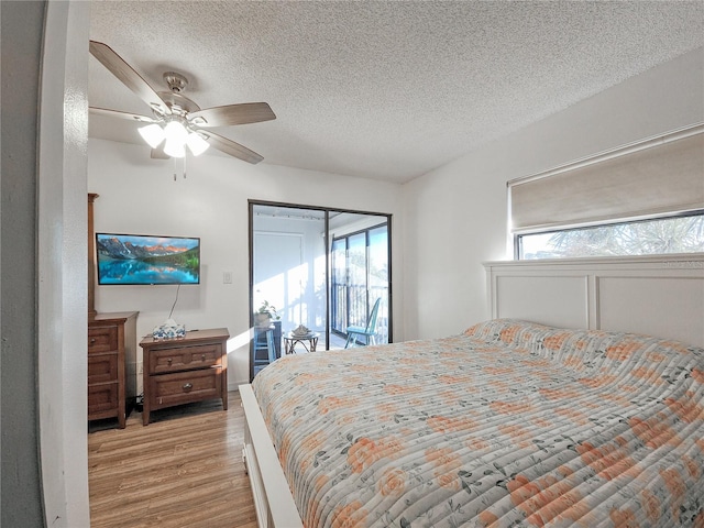 bedroom with a textured ceiling, access to outside, light hardwood / wood-style flooring, and ceiling fan