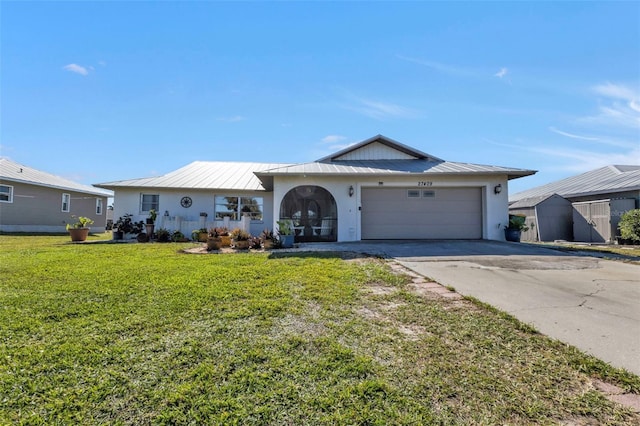 ranch-style house featuring a garage and a front lawn