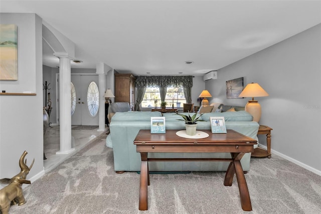 living room with french doors, light colored carpet, a wall unit AC, and decorative columns