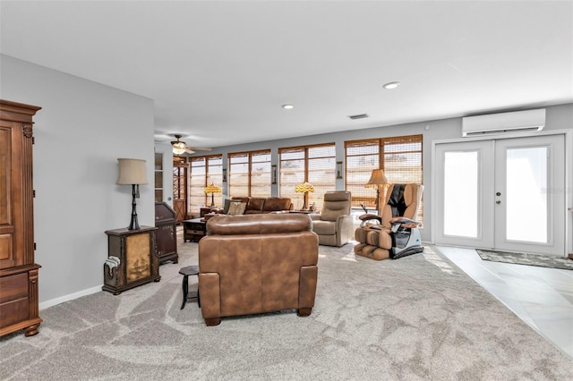 living room with light carpet, french doors, an AC wall unit, and ceiling fan