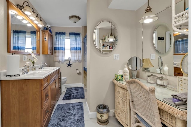 bathroom featuring tile patterned flooring, vanity, and toilet