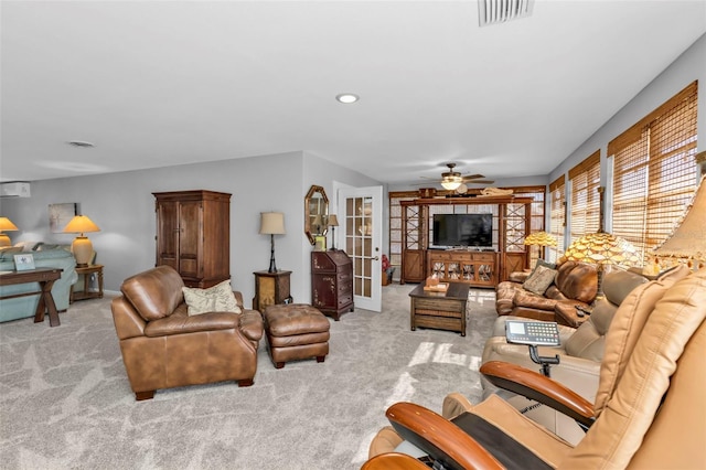 living room with ceiling fan, light carpet, and french doors