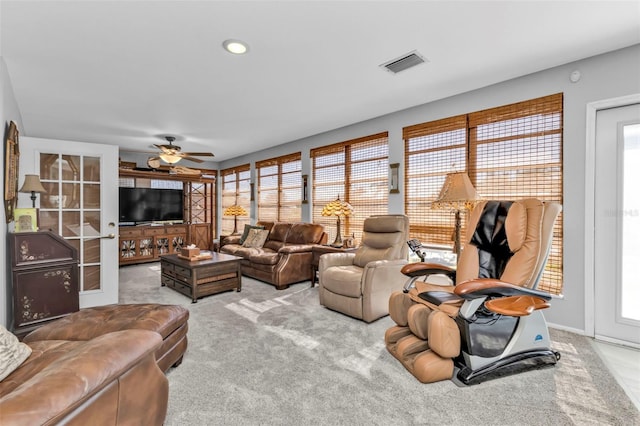 living room featuring light carpet and ceiling fan