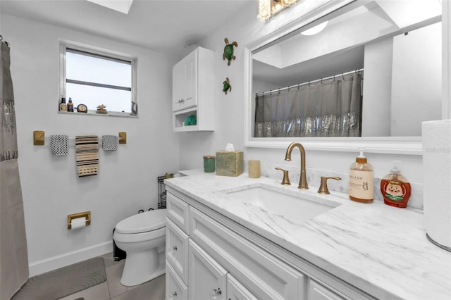 bathroom featuring tile patterned flooring, vanity, and toilet