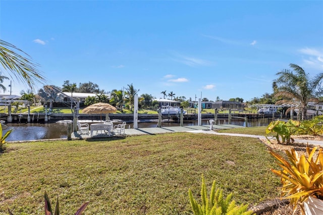 view of yard featuring a water view and a dock