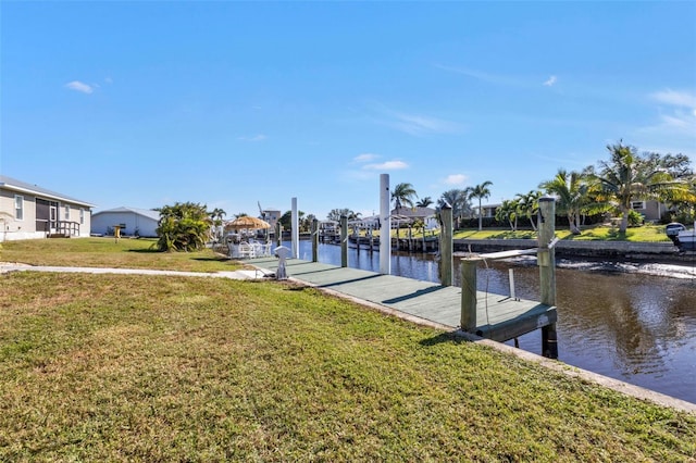 view of dock featuring a water view and a yard