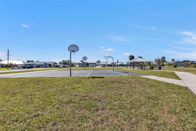 view of yard with a gazebo and basketball court