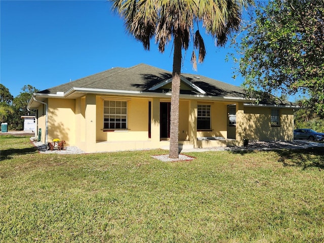 rear view of property featuring a yard