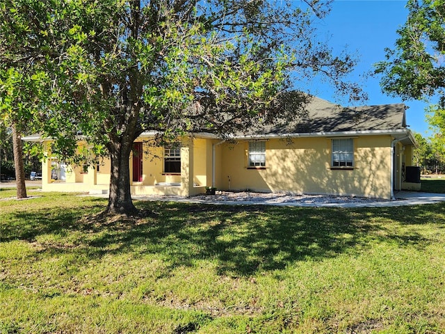 back of house with a yard