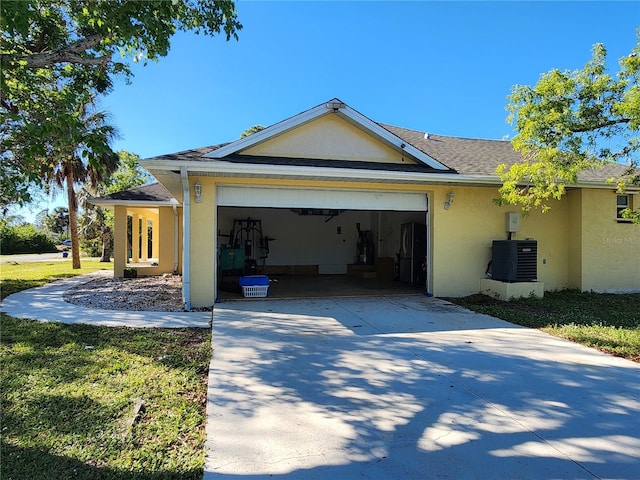 view of side of home with a garage and central air condition unit