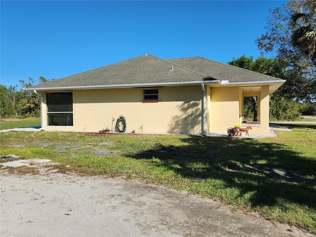 view of side of property with a lawn