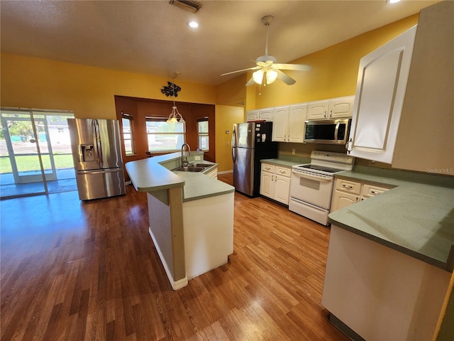 kitchen with light hardwood / wood-style floors, sink, pendant lighting, and appliances with stainless steel finishes