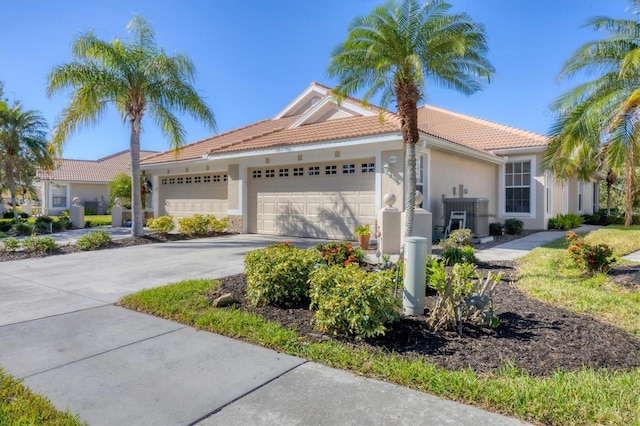 view of front of property featuring a garage and cooling unit