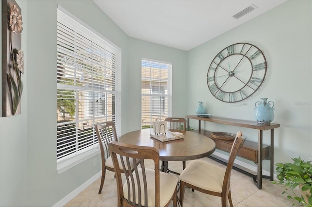 dining space featuring plenty of natural light and light tile patterned floors