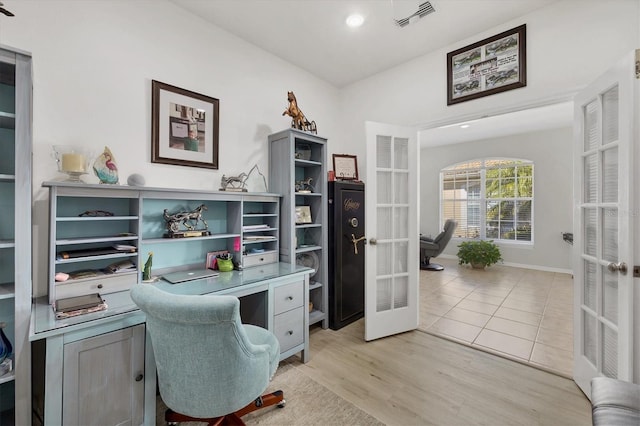 home office featuring french doors and light hardwood / wood-style floors