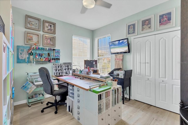 office with light hardwood / wood-style flooring and ceiling fan