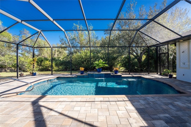 view of swimming pool with pool water feature, glass enclosure, and a patio area