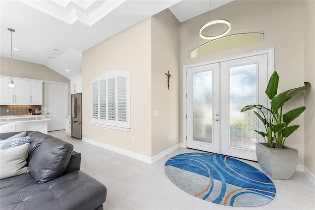 tiled entryway with vaulted ceiling, crown molding, and french doors