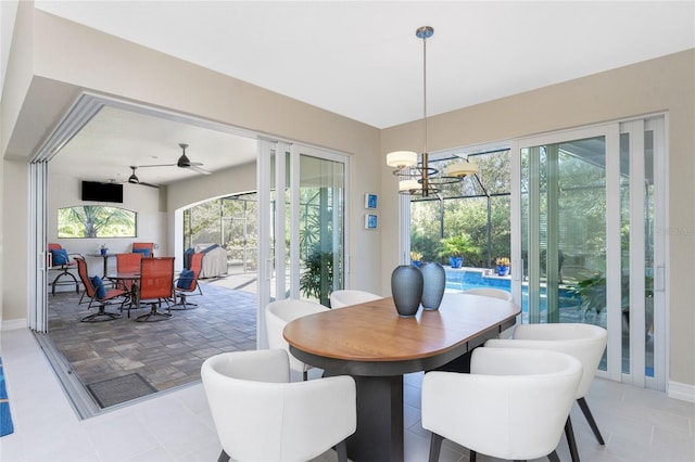 dining space with ceiling fan with notable chandelier