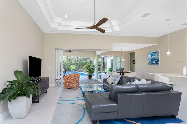 living room with light tile patterned floors, a raised ceiling, and crown molding