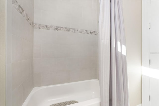 bathroom featuring shower / tub combo with curtain