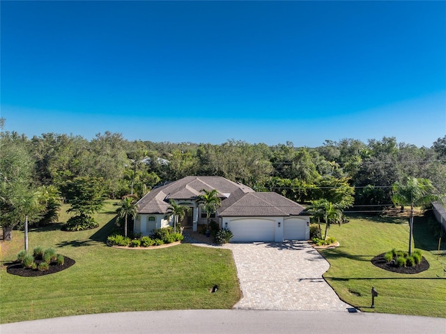 ranch-style house with a garage and a front lawn