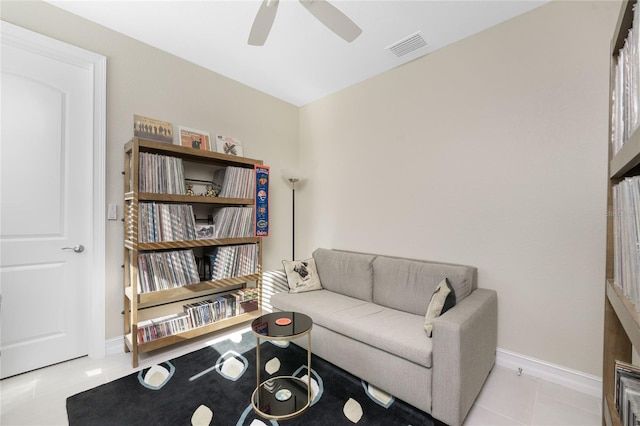 tiled living room with ceiling fan