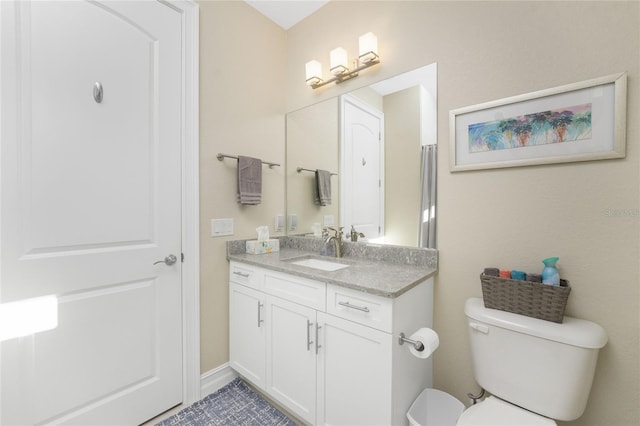 bathroom featuring vanity and toilet