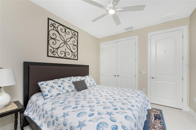 bedroom featuring light tile patterned floors, a closet, and ceiling fan