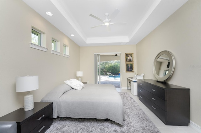 tiled bedroom with access to outside, a raised ceiling, multiple windows, and ceiling fan