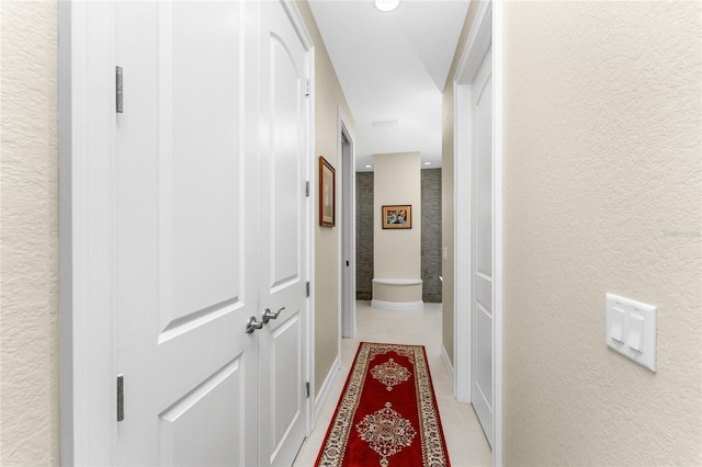 hallway featuring light tile patterned floors