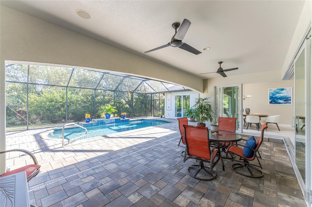 view of swimming pool featuring ceiling fan, a patio, and glass enclosure