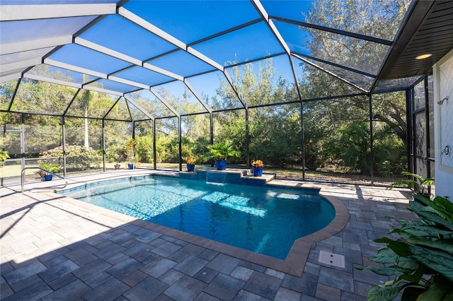 view of pool with pool water feature, a patio, and glass enclosure