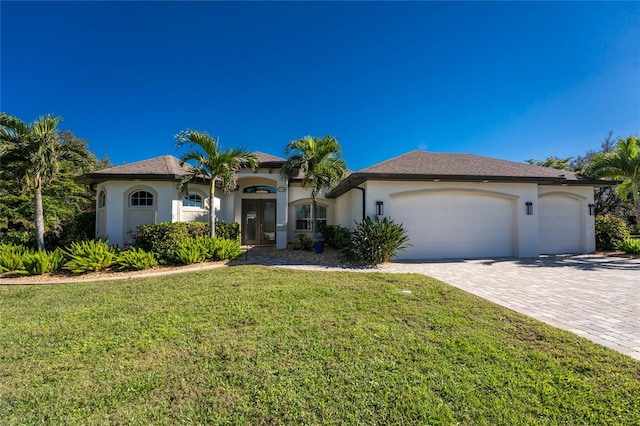 view of front of property with a front yard and a garage