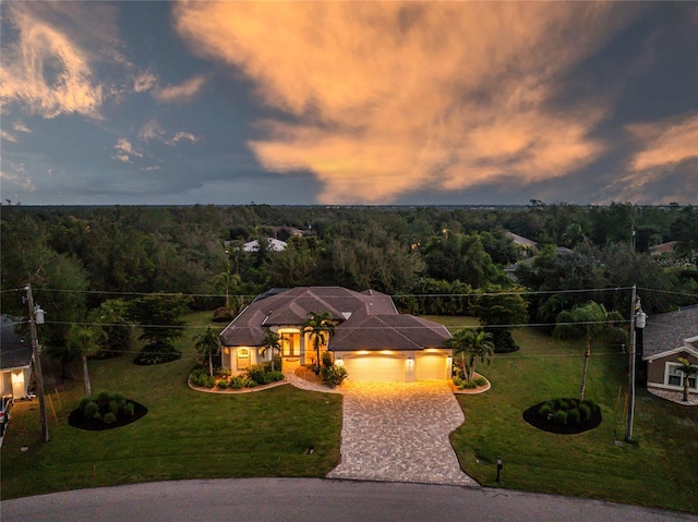 view of front of house with a lawn and a garage