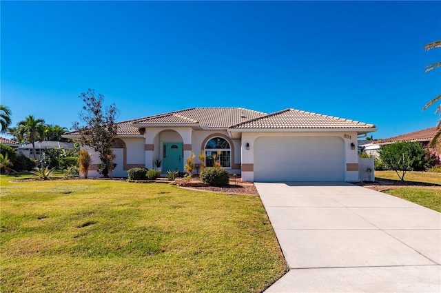 mediterranean / spanish home with a garage and a front yard