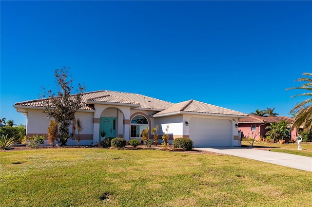 mediterranean / spanish-style house featuring a front yard and a garage