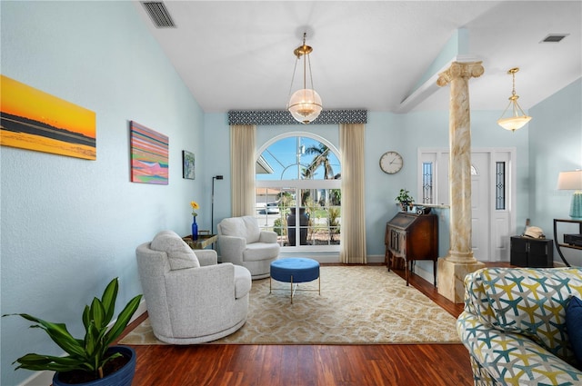 living room with wood-type flooring and ornate columns