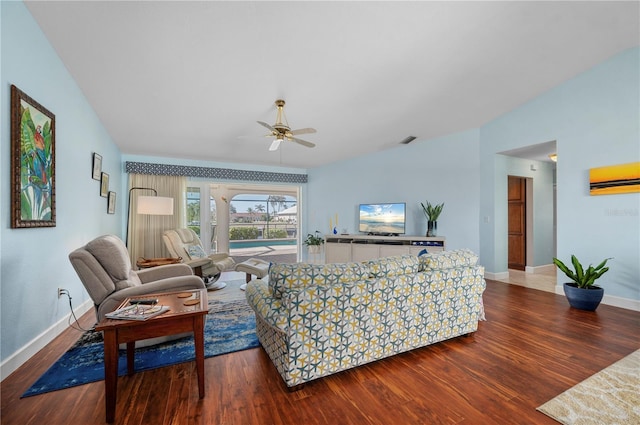 living room featuring ceiling fan, vaulted ceiling, and dark hardwood / wood-style floors