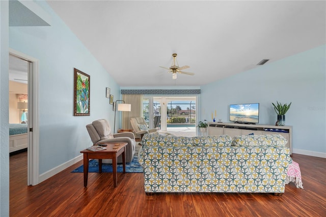 living room featuring ceiling fan, vaulted ceiling, and dark hardwood / wood-style flooring