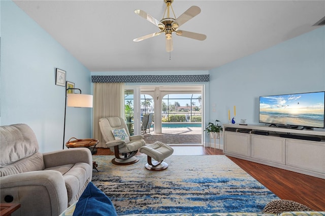 living room featuring vaulted ceiling, ceiling fan, and dark hardwood / wood-style flooring