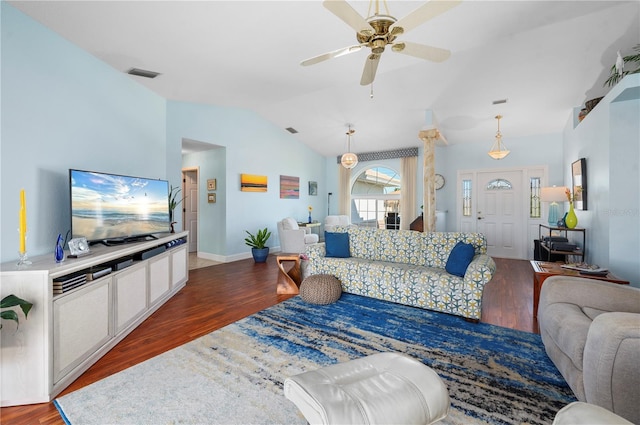 living room featuring ceiling fan, vaulted ceiling, and dark wood-type flooring