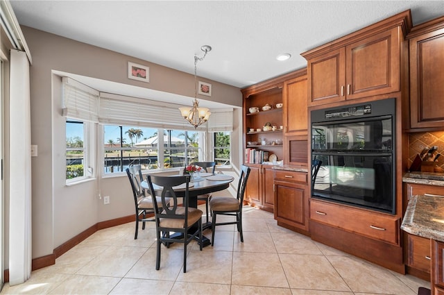 dining space featuring light tile patterned floors and an inviting chandelier