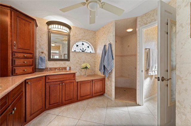 bathroom with ceiling fan, tile patterned floors, vanity, and tiled shower